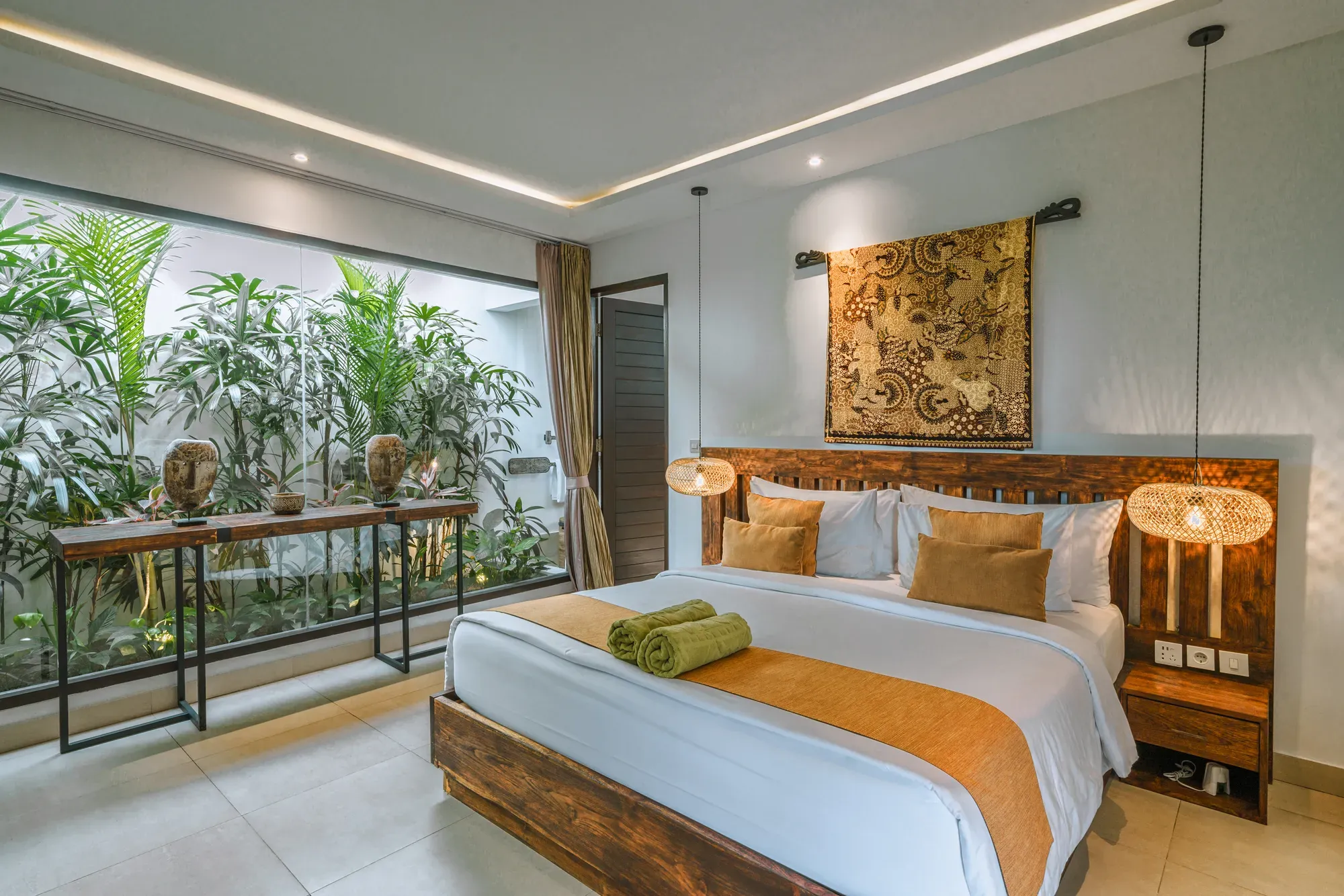 Elegant bedroom in a two-bedroom luxury pool villa with tropical garden views at K Club Ubud Bali